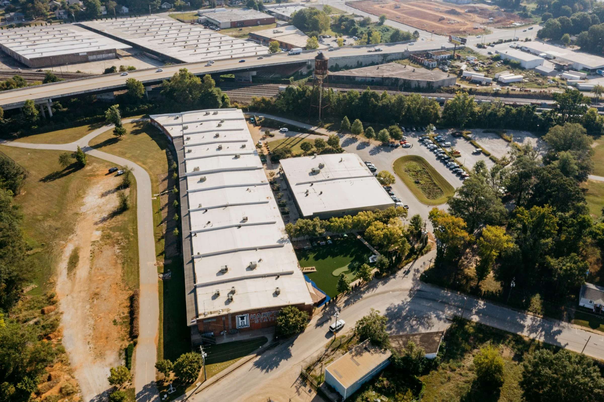 Aerial view of an industrial logistics corridor with rail and roadway connections