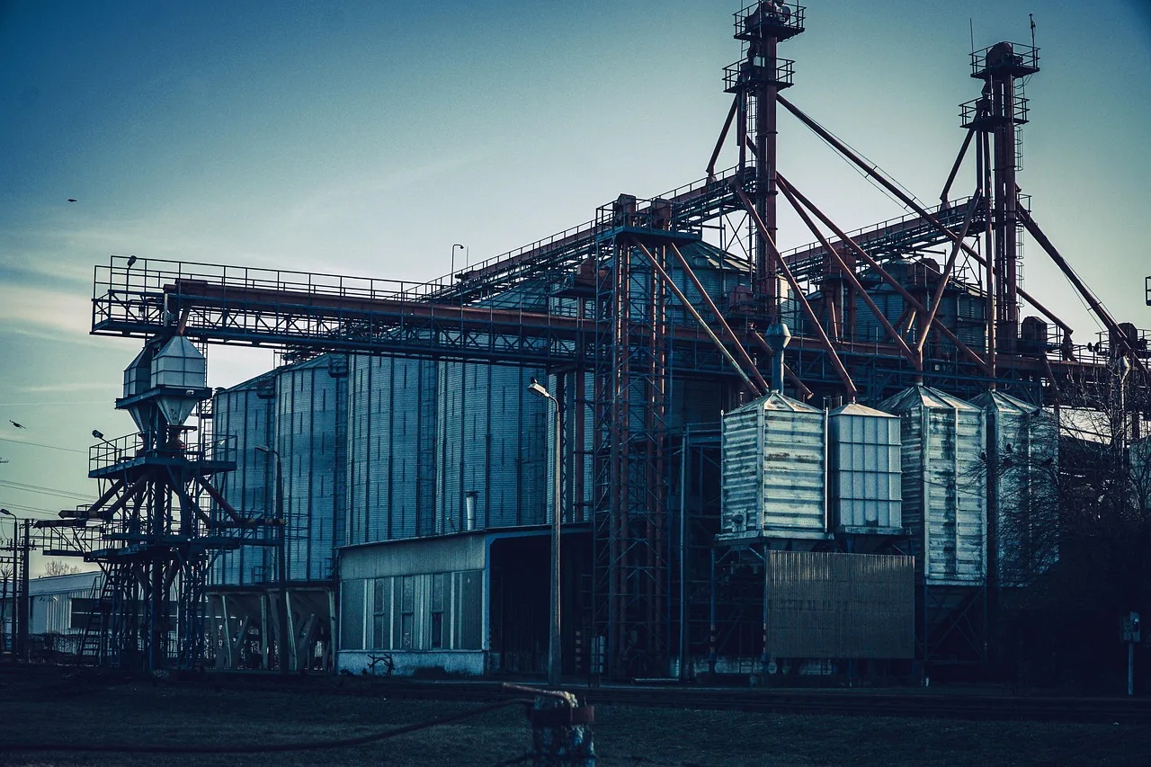 Illustrative industrial facility with storage silos and elevated structures.